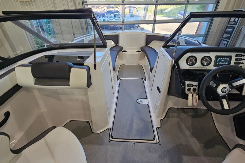 Slide: The Image of 2022 Yamaha Boats SX210 interior with modern dashboard and seating arrangement. - 13