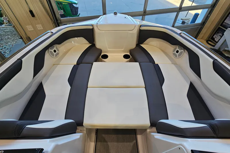 Slide: The Image of 2022 Yamaha Boats SX210 interior with cushioned seating and speakers. - 18