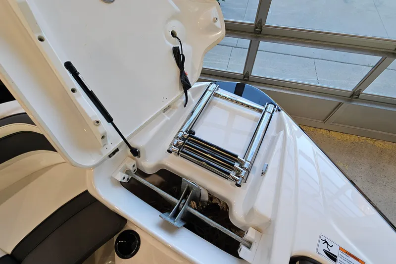 Slide: The Image of 2022 Yamaha Boats SX210 bow storage with ladder and anchor compartment. - 20