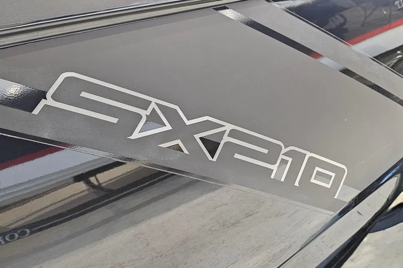 Slide: The Image of 2022 Yamaha Boats SX210 logo on sleek black surface. - 26