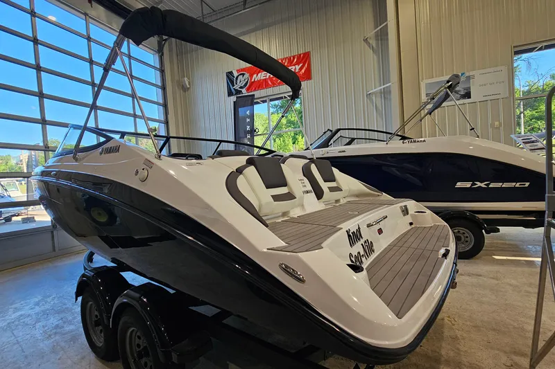 Slide: The Image of 2022 Yamaha Boats SX210 displayed in a showroom, featuring sleek design and modern amenities. - 3