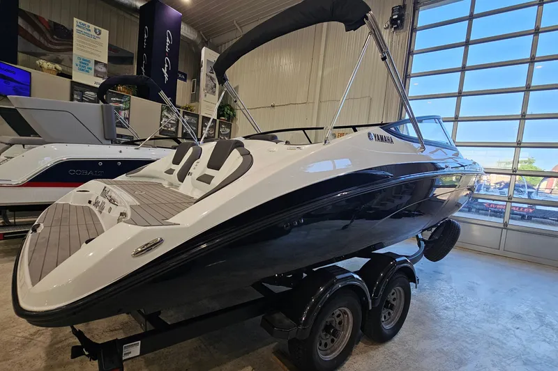 Slide: The Image of 2022 Yamaha Boats SX210 displayed indoors on a trailer. - 4