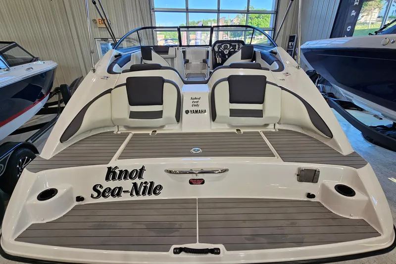 Slide: The Image of 2022 Yamaha Boats SX210 with custom "Knot Sea-Nile" name, displayed indoors. - 5