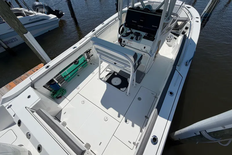 Slide: The Image of 2019 Blackfin 242 CC boat docked, featuring spacious deck and modern controls. - 10