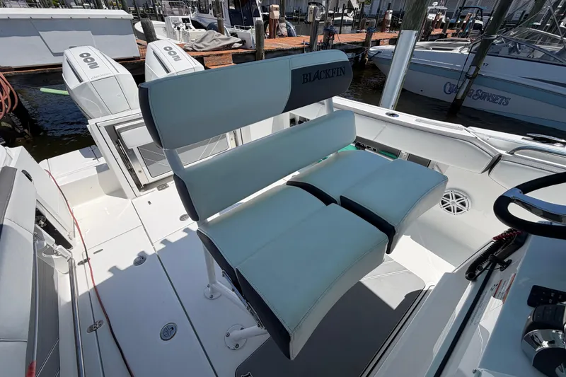 Slide: The Image of 2019 Blackfin 242 CC boat interior with dual seating and outboard motors. - 19