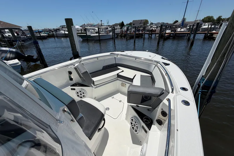 Slide: The Image of 2019 Blackfin 242 CC boat docked at marina, featuring spacious seating and modern design. - 22