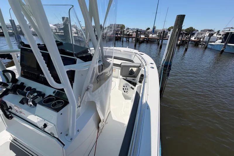 Slide: The Image of 2019 Blackfin 242 CC boat docked at marina, featuring sleek console and spacious deck. - 24