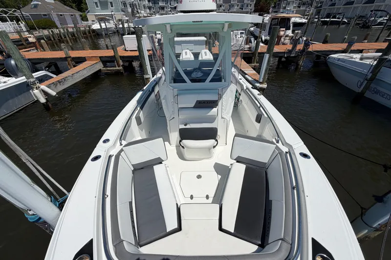 Slide: The Image of 2019 Blackfin 242 CC boat docked, featuring spacious seating and sleek design. - 26