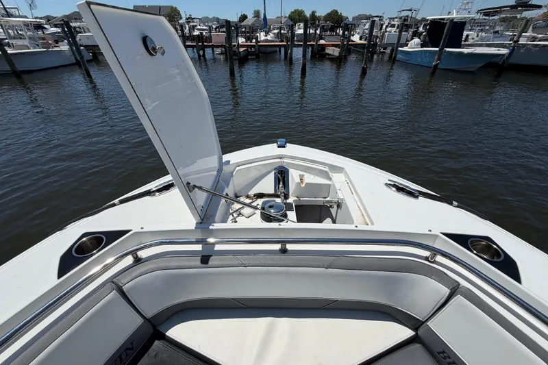 Slide: The Image of 2019 Blackfin 242 CC boat with open storage compartment at marina. - 27