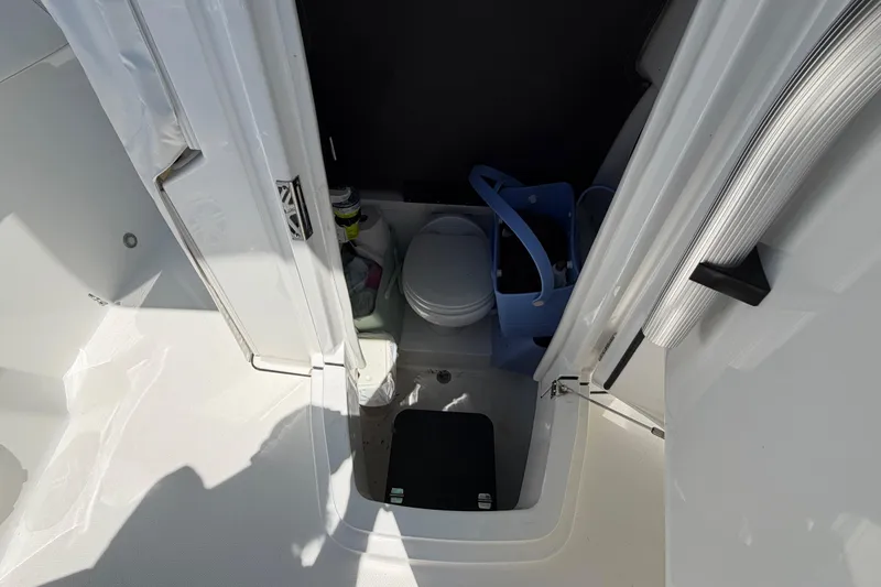 Slide: The Image of Interior view of a 2019 Blackfin 242 CC boat's compact bathroom area. - 28