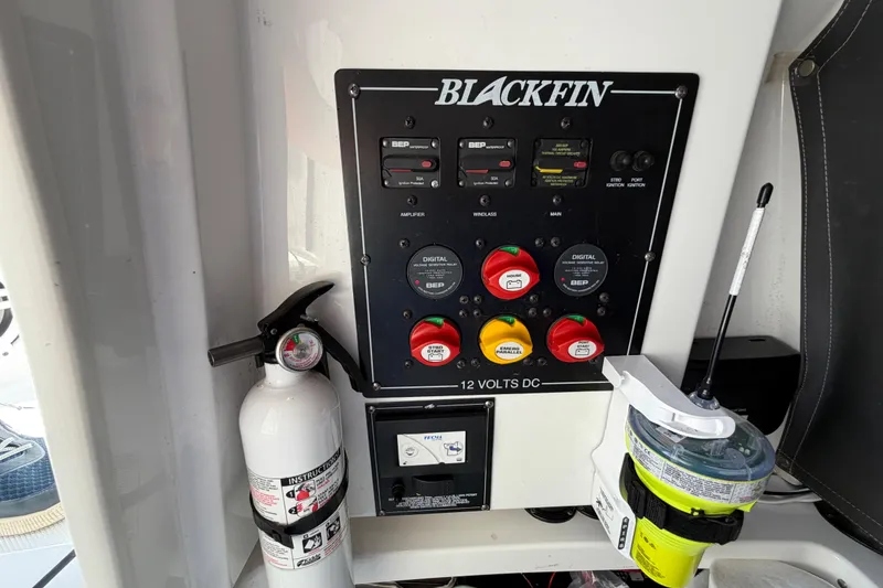 Slide: The Image of Control panel of a 2019 Blackfin 242 CC boat with fire extinguisher and safety equipment. - 29