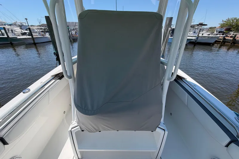 Slide: The Image of 2019 Blackfin 242 CC boat interior with covered seat, docked at marina. - 34