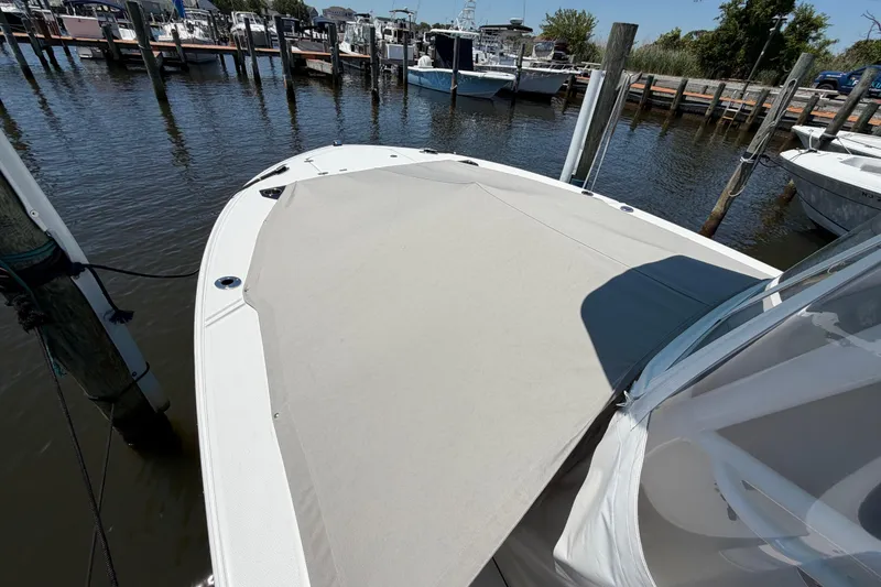 Slide: The Image of 2019 Blackfin 242 CC boat docked at marina, covered bow area. - 36