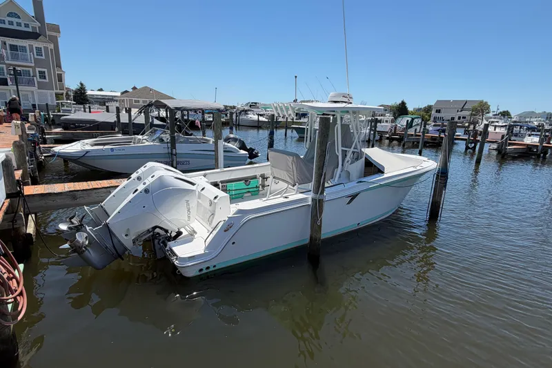 Slide: The Image of 2019 Blackfin 242 CC boat docked at a marina on a sunny day. - 37