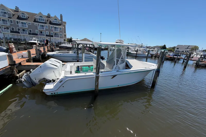 Slide: The Image of 2019 Blackfin 242 CC boat docked at marina with waterfront buildings. - 38