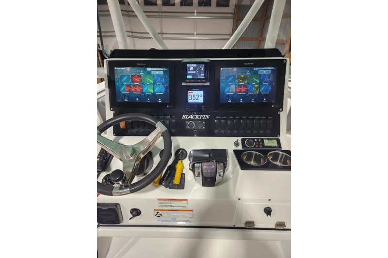 Slide: The Image of 2019 Blackfin 242 CC helm with dual Raymarine displays and steering wheel. - 6