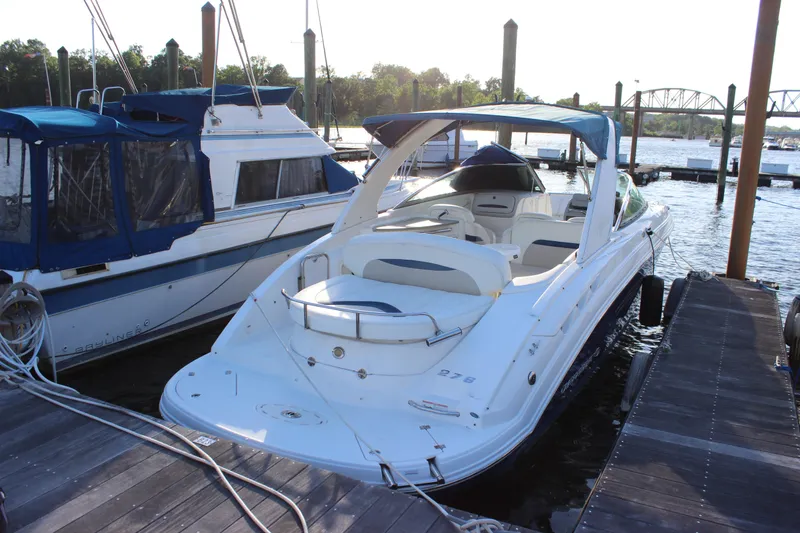 The Image of 2007 Chaparral 276 SSX boat docked at marina, featuring sleek design and spacious seating. - 0