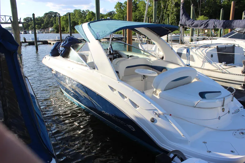 Slide: The Image of 2007 Chaparral 276 SSX boat docked at marina, featuring blue and white design. - 1