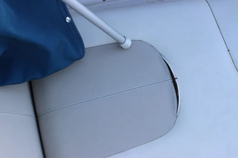 Slide: The Image of Torn seat upholstery on 2007 Chaparral 276 SSX boat with blue cover and metal pole. - 15