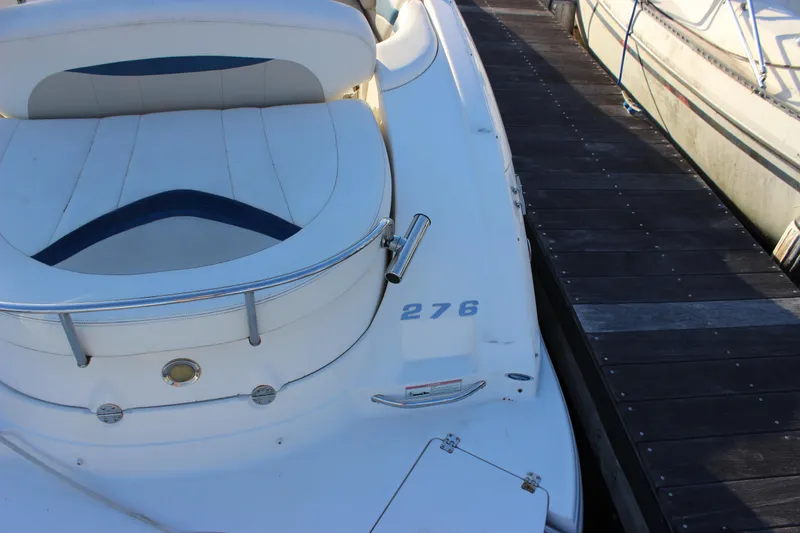 Slide: The Image of 2007 Chaparral 276 SSX boat docked, featuring white seating and sleek design. - 2