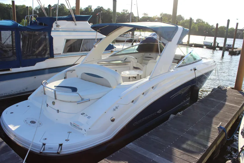 Slide: The Image of 2007 Chaparral 276 SSX boat docked at a marina, showcasing sleek design and spacious seating. - 3