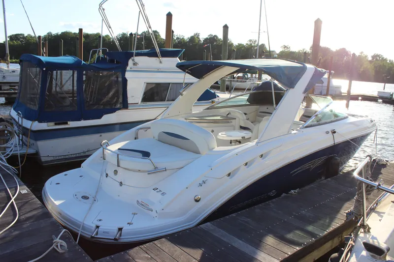 Slide: The Image of 2007 Chaparral 276 SSX boat docked at marina, sunny day, blue and white design. - 4