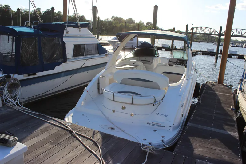 Slide: The Image of 2007 Chaparral 276 SSX boat docked at marina, surrounded by water and other vessels. - 5