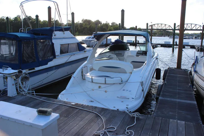 Slide: The Image of 2007 Chaparral 276 SSX boat docked at marina, surrounded by other vessels. - 7