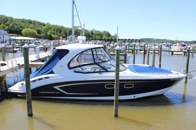 The Image of 2012 Chaparral 327 SSX boat docked at a marina on a sunny day. - 0
