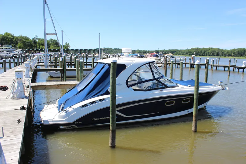 Slide: The Image of 2012 Chaparral 327 SSX boat docked at a marina on a sunny day. - 1