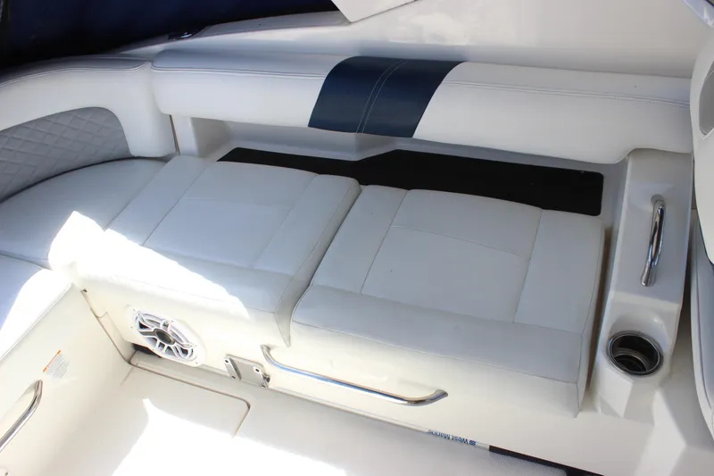 Slide: The Image of 2012 Chaparral 327 SSX boat interior with white cushioned seating and speaker. - 12