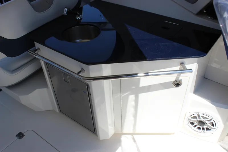 Slide: The Image of 2012 Chaparral 327 SSX boat interior with sink and storage area. - 13