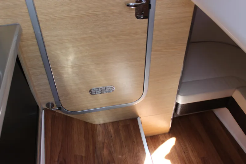 Slide: The Image of Interior cabin of 2012 Chaparral 327 SSX with wood flooring and compact seating area. - 15
