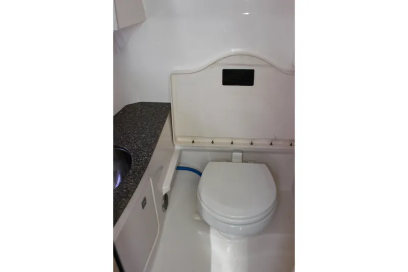 Slide: The Image of 2012 Chaparral 327 SSX boat bathroom with toilet and countertop sink. - 18