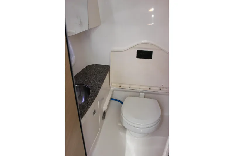 Slide: The Image of 2012 Chaparral 327 SSX boat bathroom with toilet and sink. - 19
