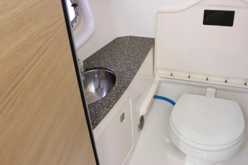 Slide: The Image of 2012 Chaparral 327 SSX boat bathroom with sink and toilet. - 20