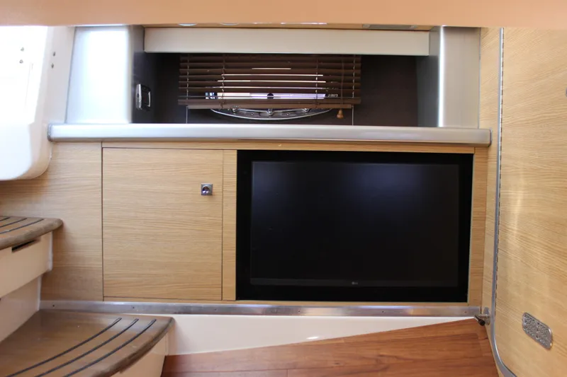 Slide: The Image of Interior of 2012 Chaparral 327 SSX boat with TV and wooden cabinetry. - 21