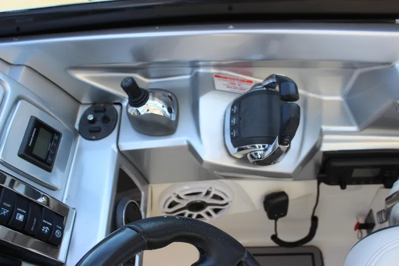 Slide: The Image of 2012 Chaparral 327 SSX boat dashboard with controls and steering wheel. - 22