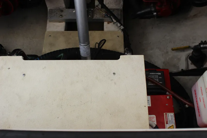 Slide: The Image of Engine compartment of a 2012 Chaparral 327 SSX boat, featuring mechanical components. - 26