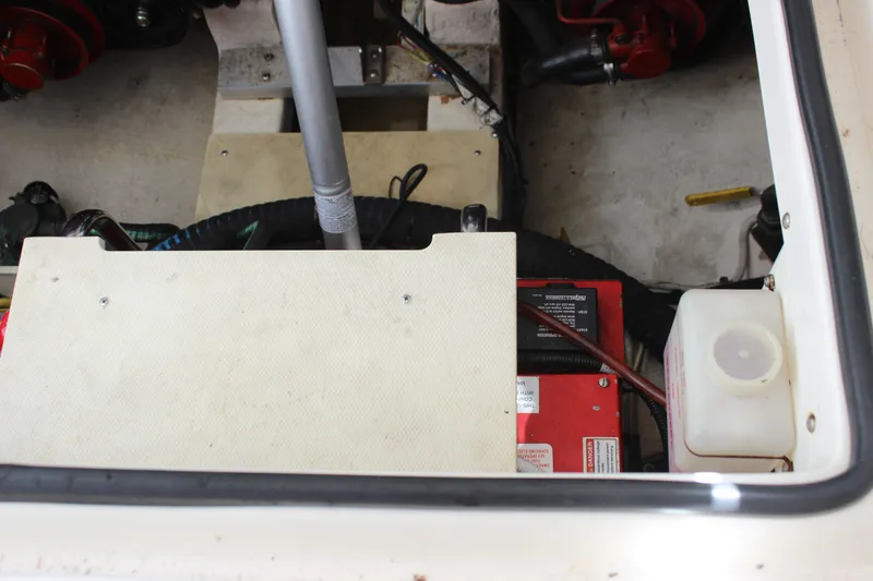 Slide: The Image of Engine compartment of a 2012 Chaparral 327 SSX boat, featuring battery and components. - 27