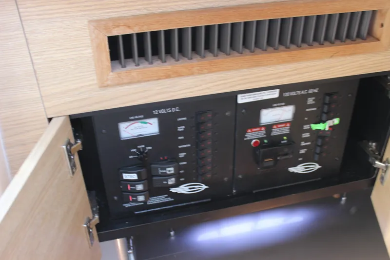 Slide: The Image of Electrical panel inside 2012 Chaparral 327 SSX boat, featuring control switches and gauges. - 31