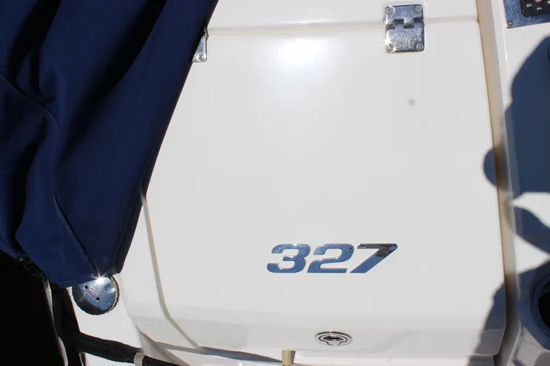 Slide: The Image of 2012 Chaparral 327 SSX boat with blue cover and chrome details. - 32