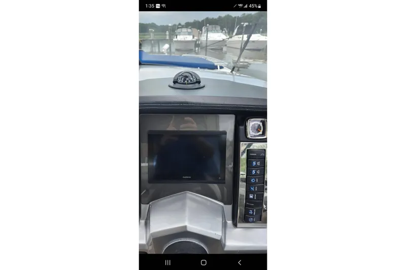 Slide: The Image of Dashboard of a 2012 Chaparral 327 SSX boat with navigation screen and compass. - 36