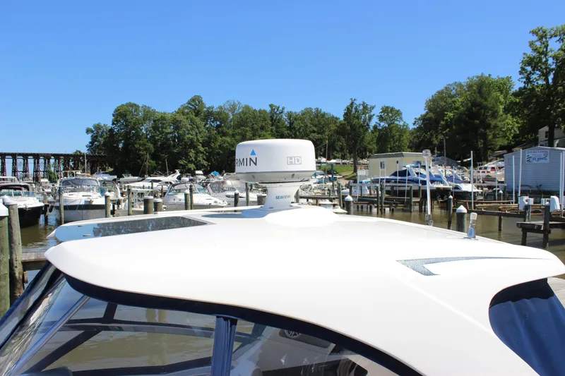 Slide: The Image of Chaparral 327 SSX 2012 boat docked at marina with Garmin radar, surrounded by other boats. - 6