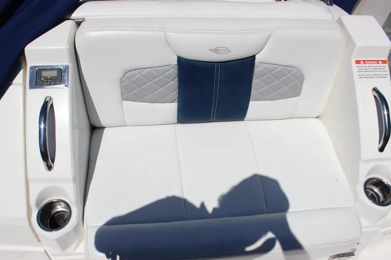 Slide: The Image of White and blue seating on a 2012 Chaparral 327 SSX boat with cup holders and control panel. - 7