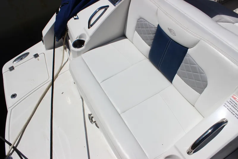 Slide: The Image of 2012 Chaparral 327 SSX boat seating area with white and blue upholstery. - 8