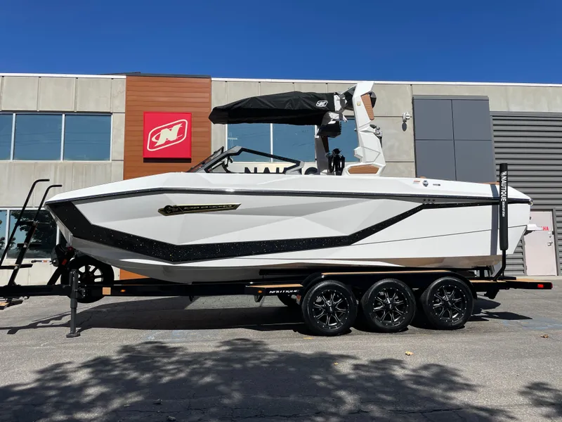 The Image of 2025 Nautique G23 boat parked in front of a modern building. - 1