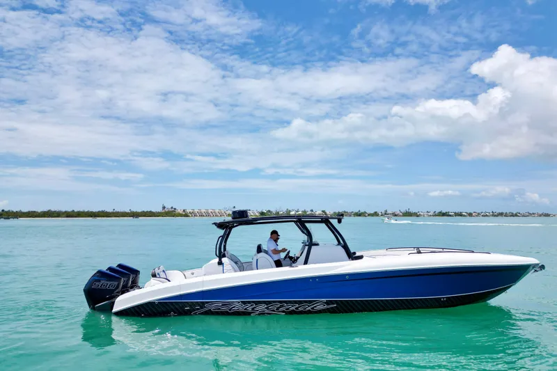The Image of 2024 Renegade 38 Open boat cruising on clear turquoise waters under a blue sky. - 0