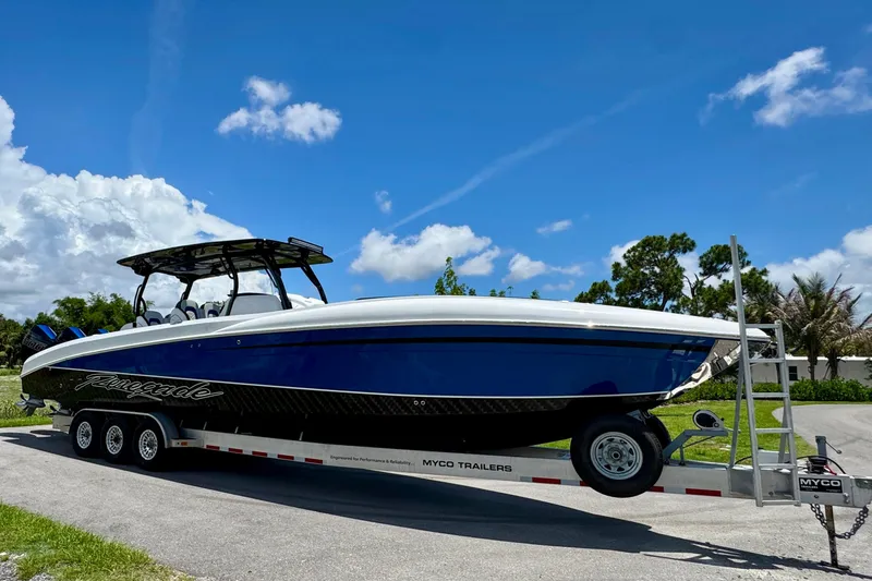 Slide: The Image of 2024 Renegade 38 Open boat on trailer under clear blue sky. - 11