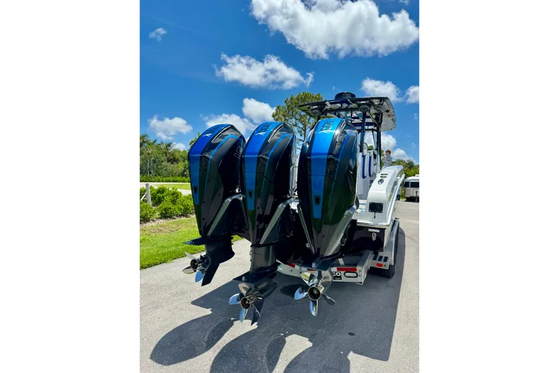 Slide: The Image of 2024 Renegade 38 Open boat with triple outboard engines on a sunny day. - 21